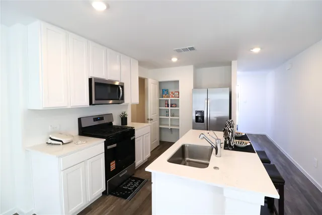 a kitchen that has a sink and a stove in it