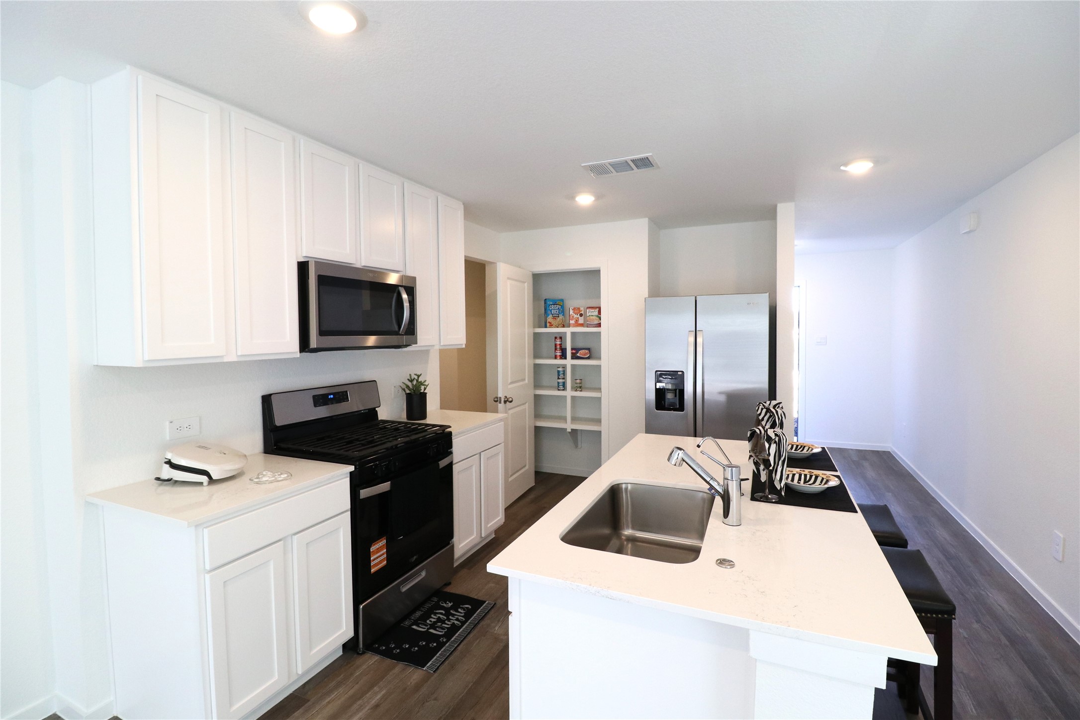 24134 Chirp Street Splendora, TX 77372 - Photo 6 of 14 a kitchen that has a sink and a stove in it
