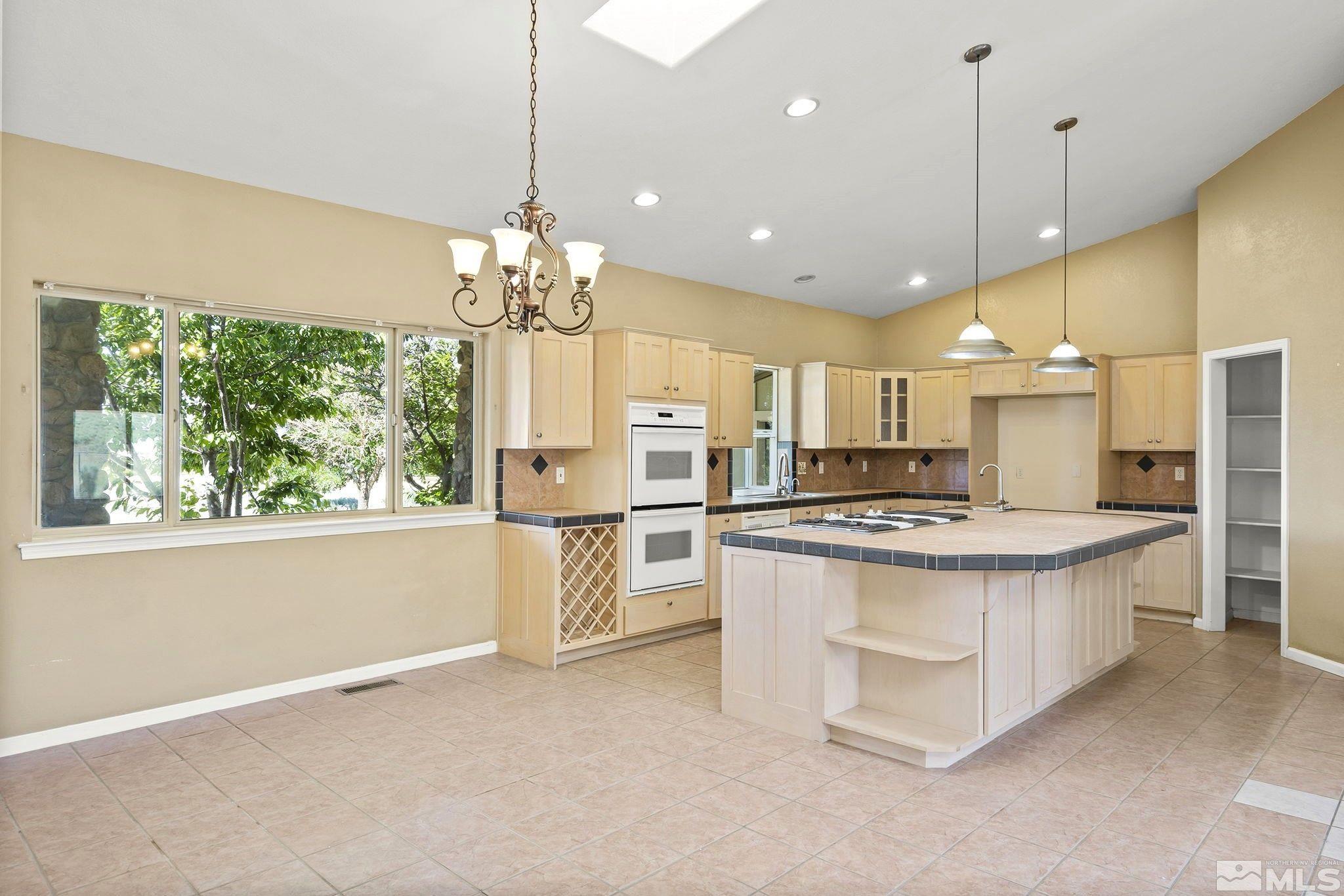 1683 Windmill Road Gardnerville, NV 89410 - Photo 1 of 40 a kitchen with stainless steel appliances granite countertop a stove oven and a refrigerator