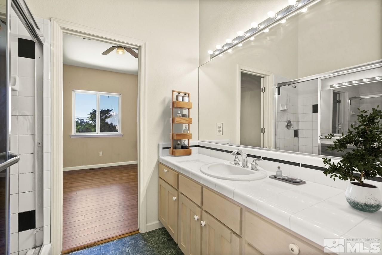 1683 Windmill Road Gardnerville, NV 89410 - Photo 18 of 40 a bathroom with a sink and a mirror