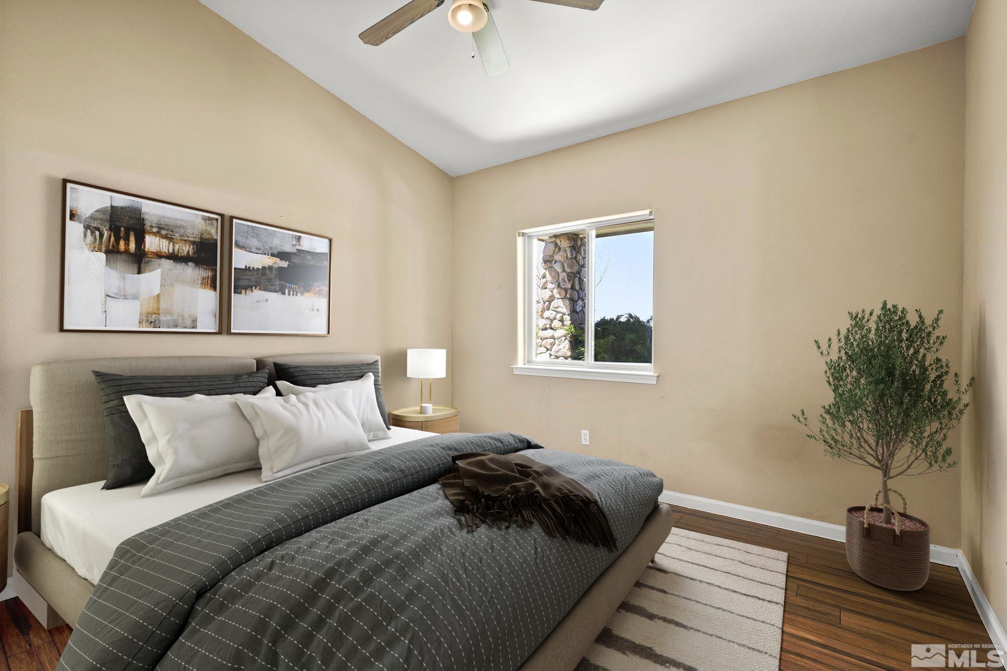 1683 Windmill Road Gardnerville, NV 89410 - Photo 26 of 40 a bedroom with a bed and a potted plant