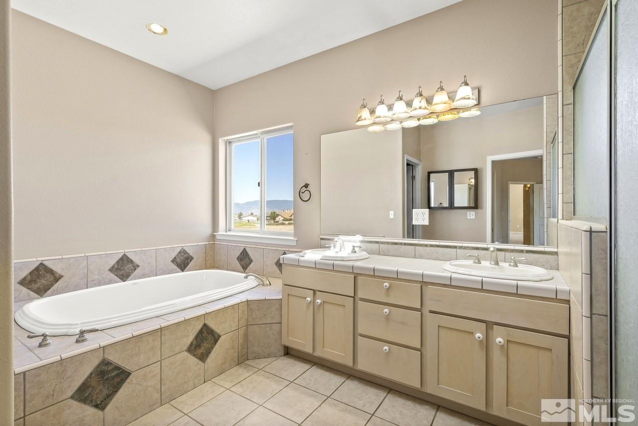 1683 Windmill Road Gardnerville, NV 89410 - Photo 29 of 40 a bathroom with a double vanity sink and a mirror