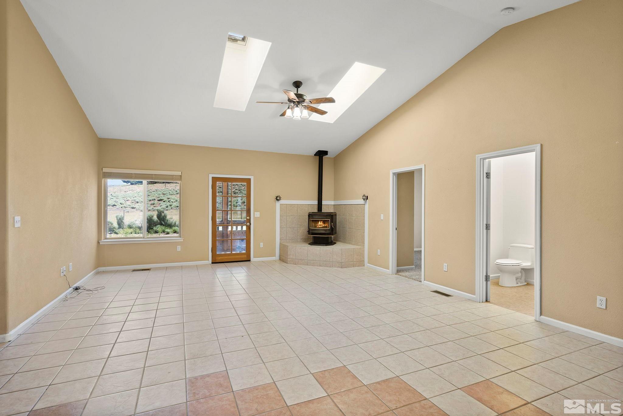 1683 Windmill Road Gardnerville, NV 89410 - Photo 32 of 40 a view of a livingroom with a chandelier fan and windows