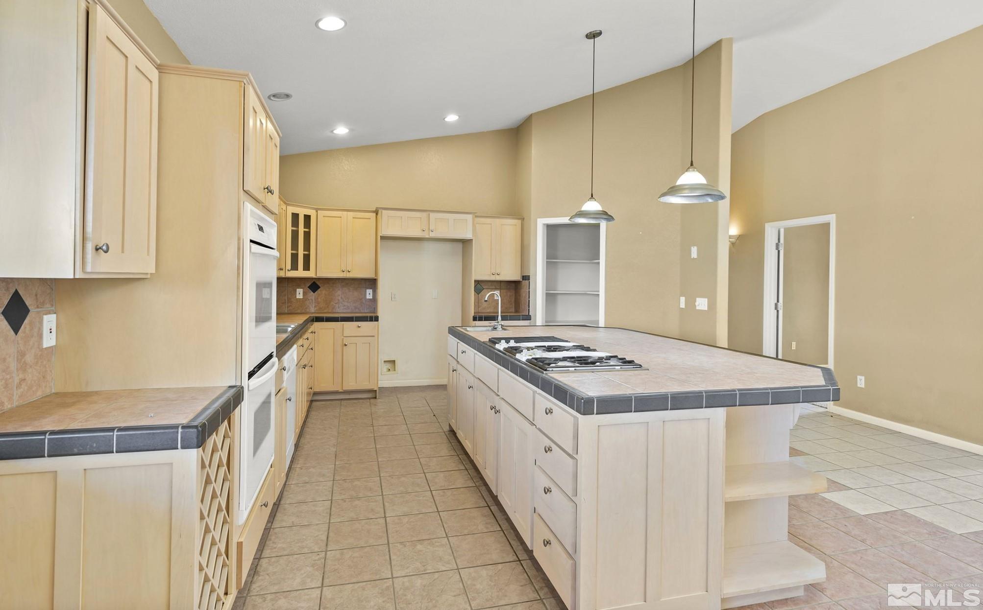 1683 Windmill Road Gardnerville, NV 89410 - Photo 38 of 40 a kitchen with stainless steel appliances a stove a sink and a refrigerator