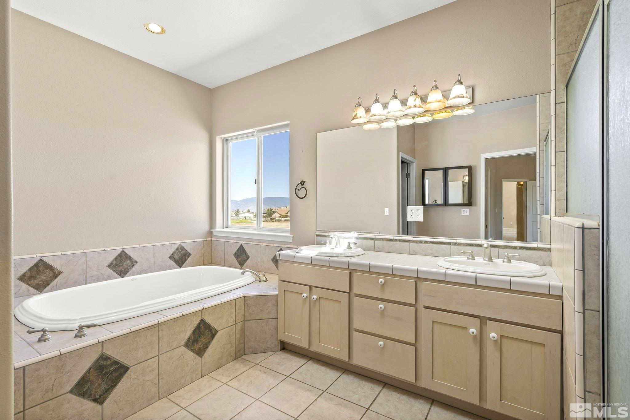 1683 Windmill Road Gardnerville, NV 89410 - Photo 9 of 40 a bathroom with a double vanity sink and a mirror