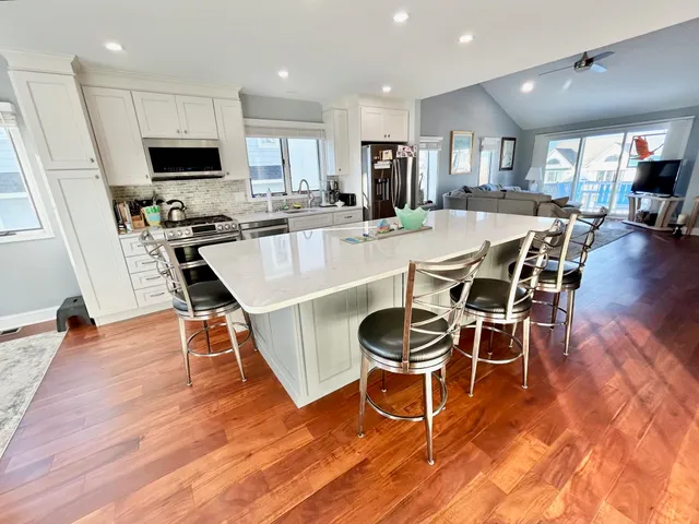 a large kitchen with a table and chairs
