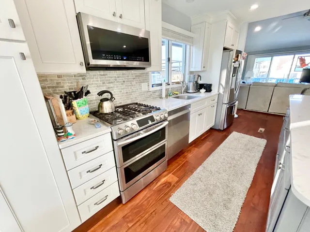 a kitchen with stainless steel appliances granite countertop a stove and a sink