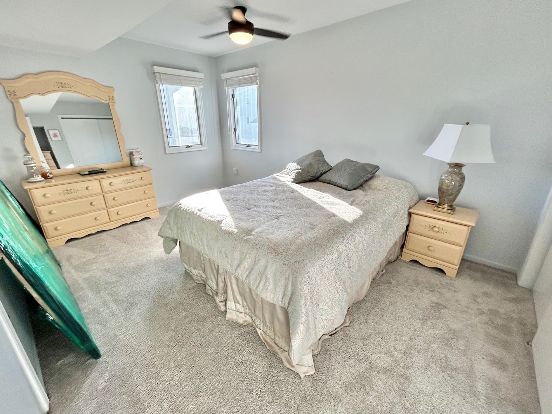 26 73rd Street, Unit WEST Sea Isle City, NJ 08243 - Photo 14 of 21 a bedroom with a bed and window