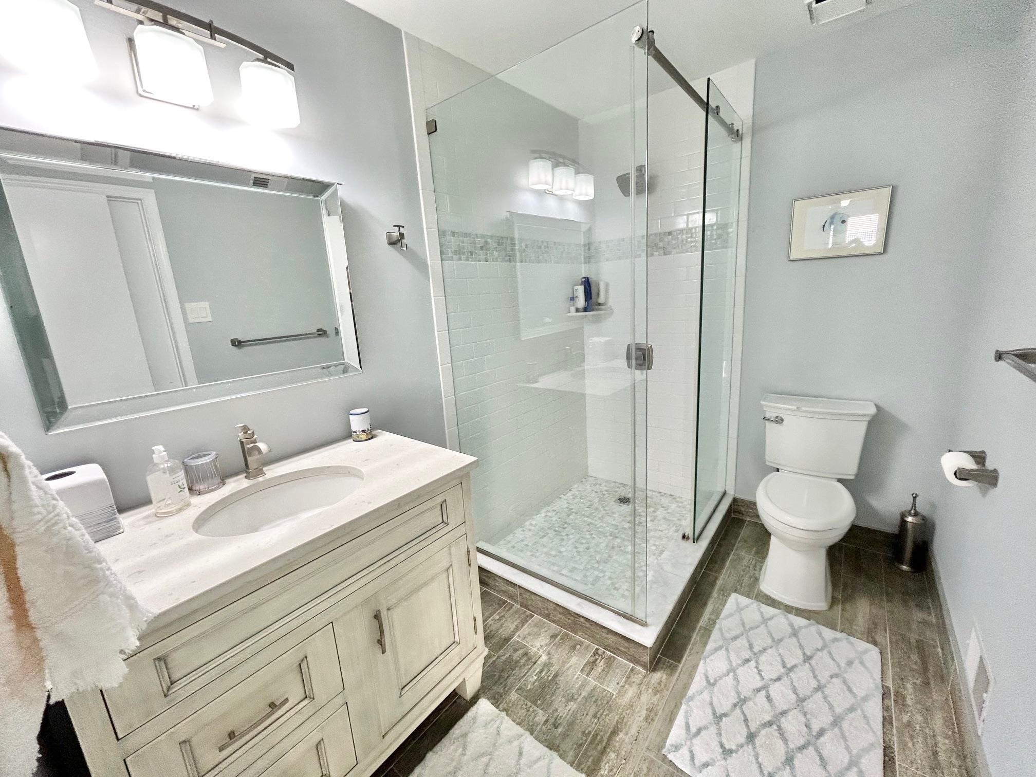26 73rd Street, Unit WEST Sea Isle City, NJ 08243 - Photo 15 of 21 a bathroom with a sink and a mirror