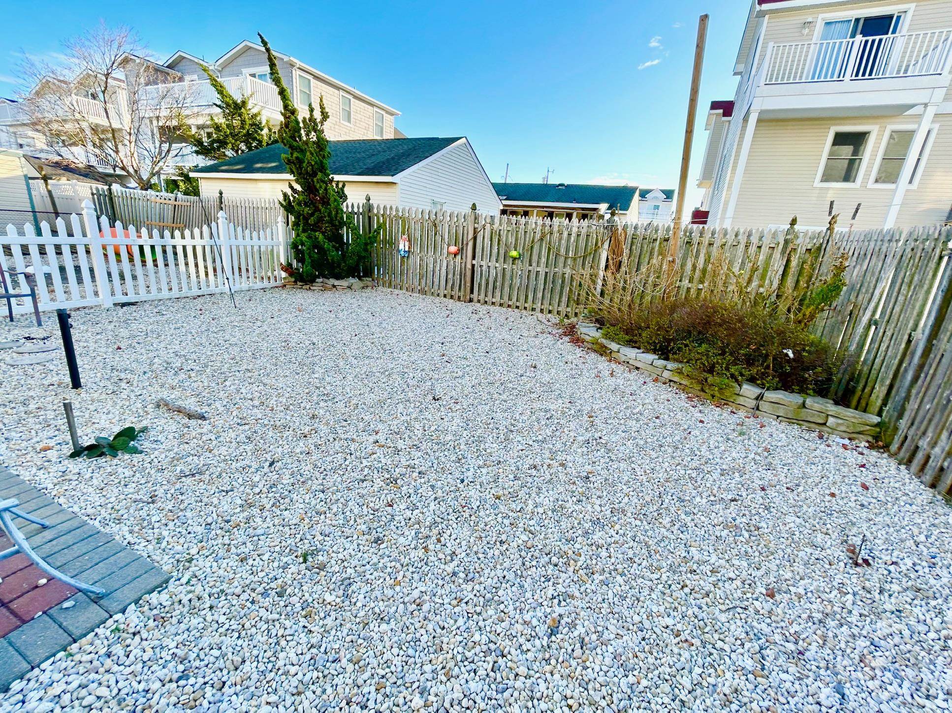 26 73rd Street, Unit WEST Sea Isle City, NJ 08243 - Photo 5 of 21 a view of a house with a yard