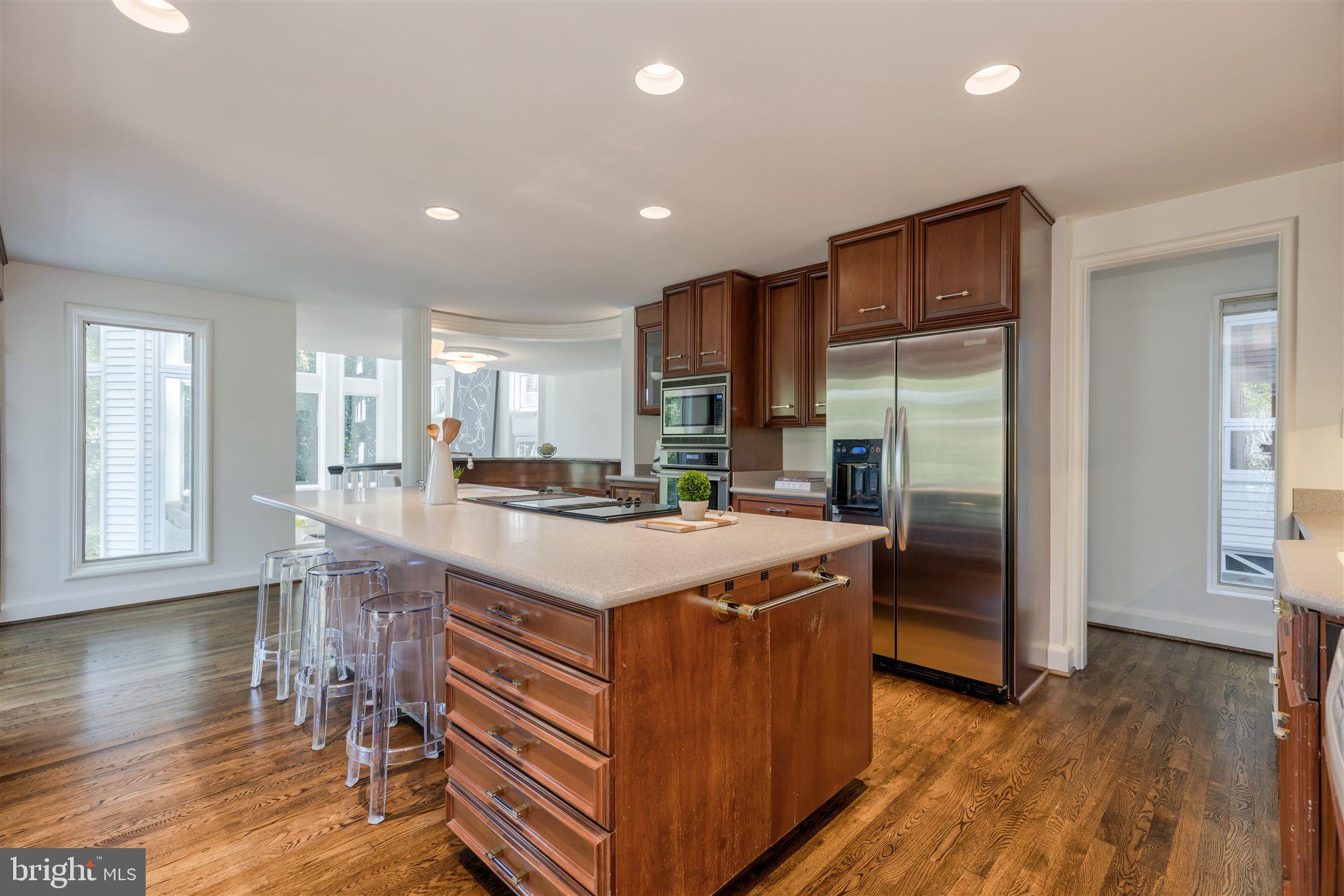 1371 Kirby Road McLean, VA 22101 - Photo 14 of 36 a kitchen with kitchen island granite countertop a stove and a refrigerator