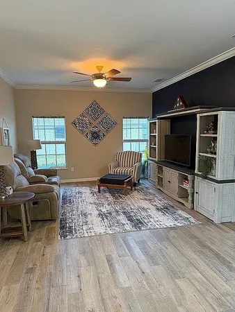 a living room with furniture and a flat screen tv
