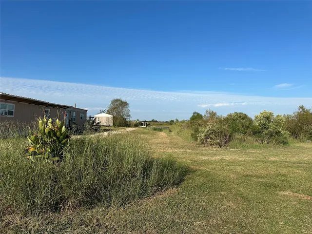 a view of a field with an ocean