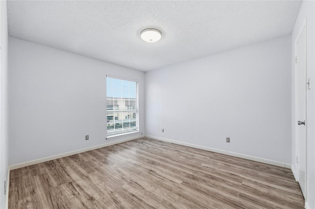 12482 Abrams Road, Unit 1327 Dallas, TX 75243 - Photo 14 of 32 a view of empty room with wooden floor and fan