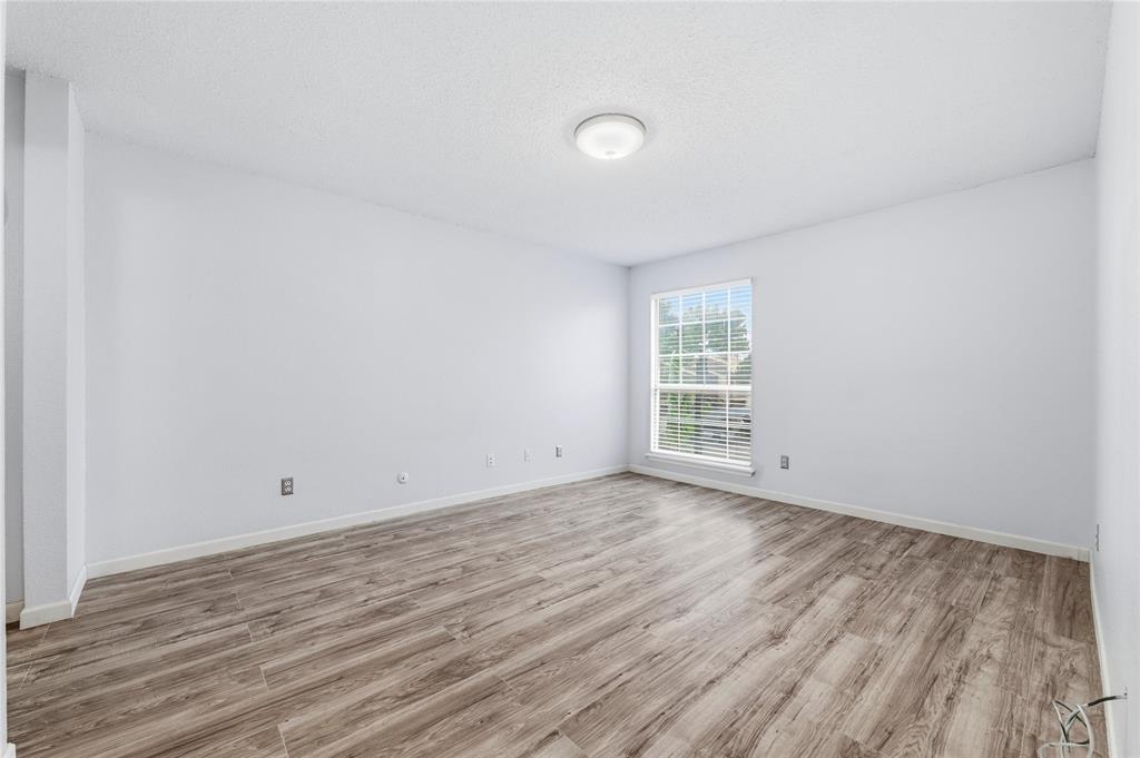 12482 Abrams Road, Unit 1327 Dallas, TX 75243 - Photo 16 of 32 a view of a room with wooden floor and window