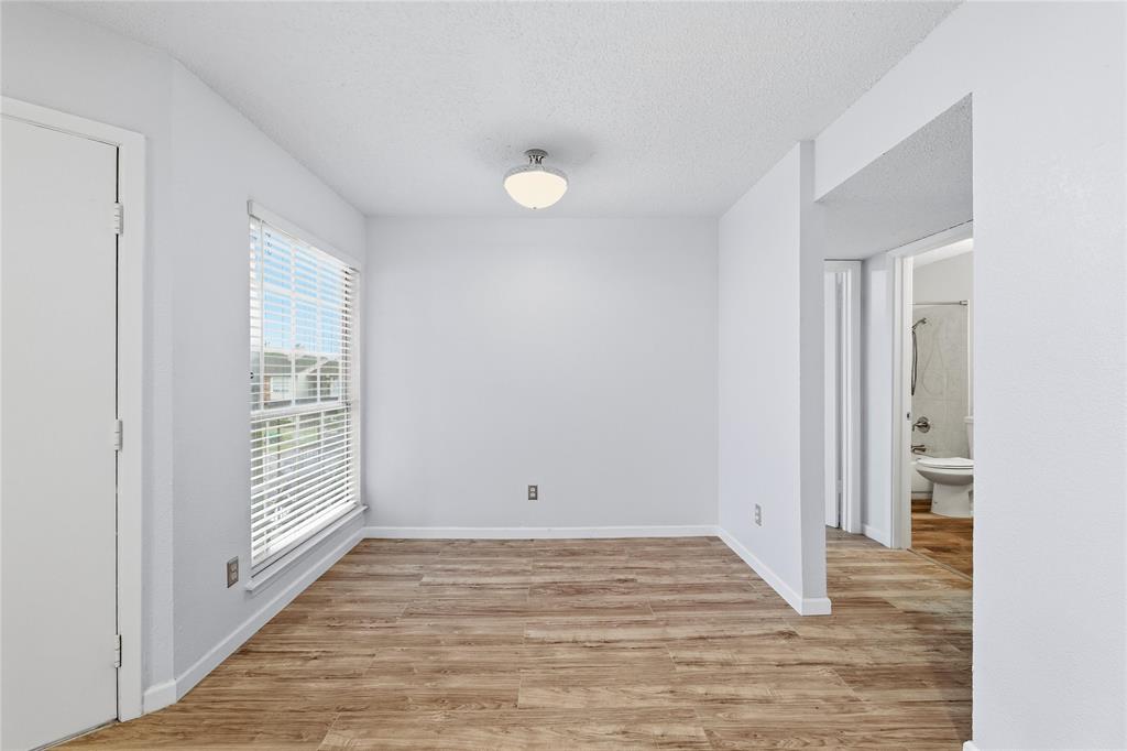 12482 Abrams Road, Unit 1327 Dallas, TX 75243 - Photo 4 of 32 a view of empty room with wooden floor and fan
