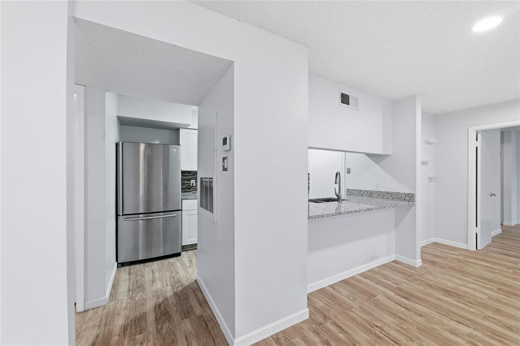 12482 Abrams Road, Unit 1327 Dallas, TX 75243 - Photo 6 of 32 a kitchen with a refrigerator and a stove top oven