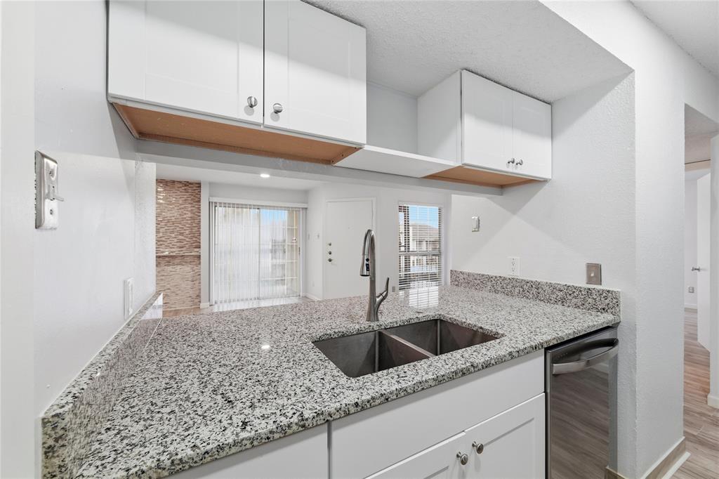 12482 Abrams Road, Unit 1327 Dallas, TX 75243 - Photo 9 of 32 a kitchen with stainless steel appliances granite countertop a sink a refrigerator and cabinets