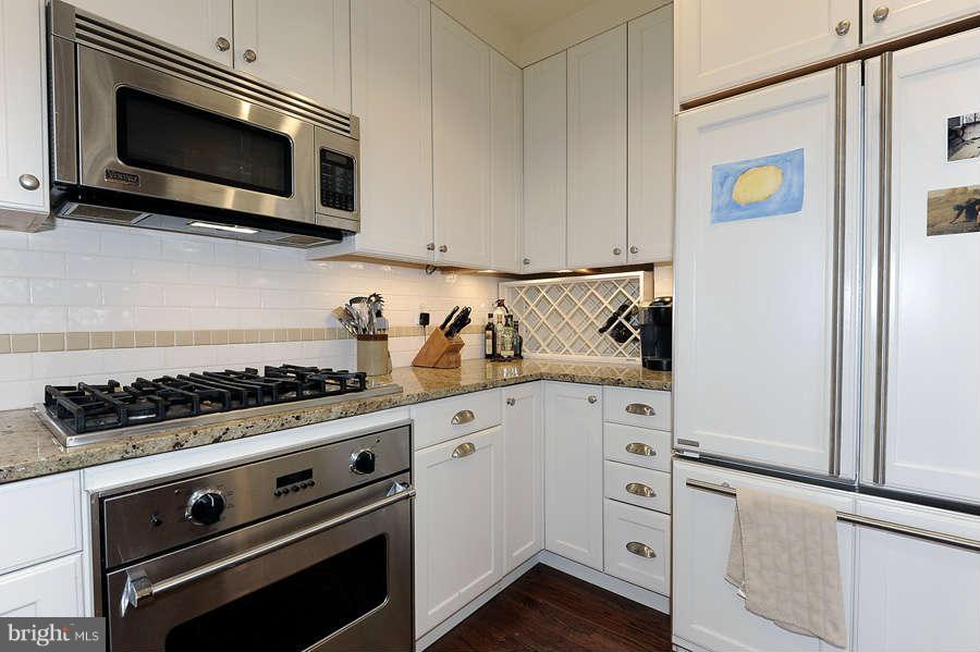 3000 Tilden Street Northwest, Unit 102 Washington, DC 20008 - Photo 12 of 29 a kitchen with white cabinets and appliances
