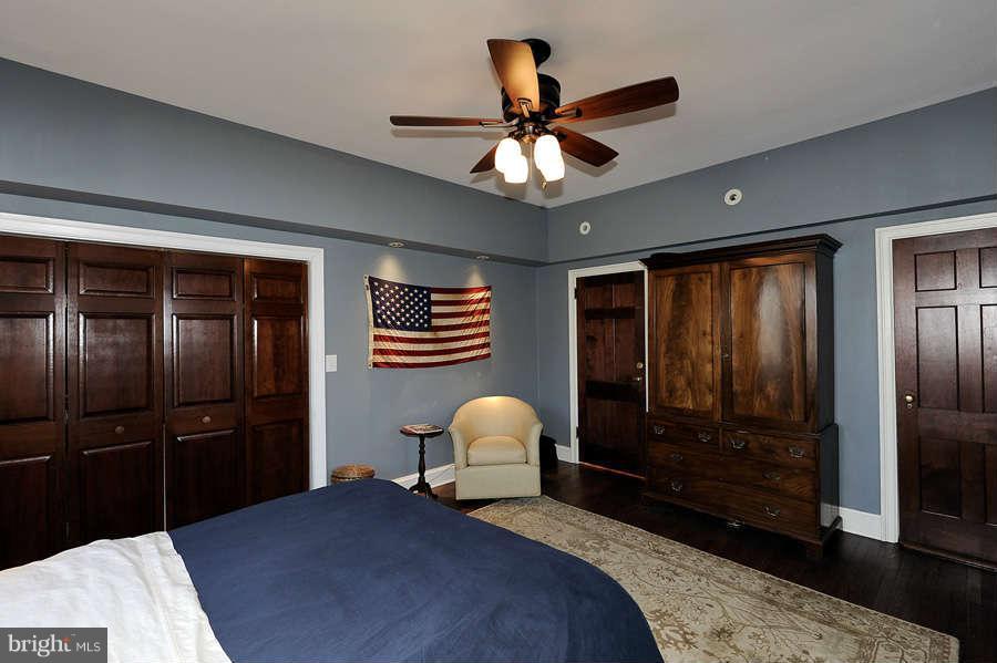 3000 Tilden Street Northwest, Unit 102 Washington, DC 20008 - Photo 16 of 29 a bedroom with a bed and a walk in closet