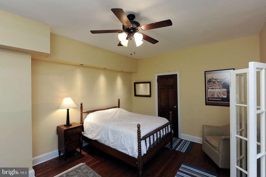 3000 Tilden Street Northwest, Unit 102 Washington, DC 20008 - Photo 19 of 29 a bedroom with a bed and a chandelier