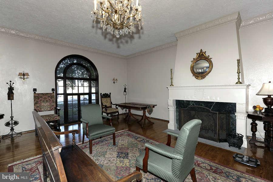 3000 Tilden Street Northwest, Unit 102 Washington, DC 20008 - Photo 23 of 29 a living room with furniture a fireplace and a floor to ceiling window
