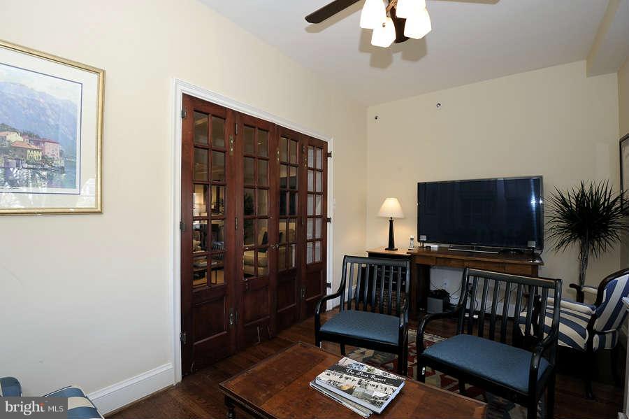3000 Tilden Street Northwest, Unit 102 Washington, DC 20008 - Photo 10 of 29 a living room with furniture a flat screen tv and a bookshelf
