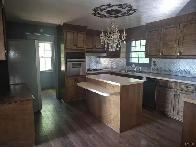 a kitchen with a sink stove and cabinets