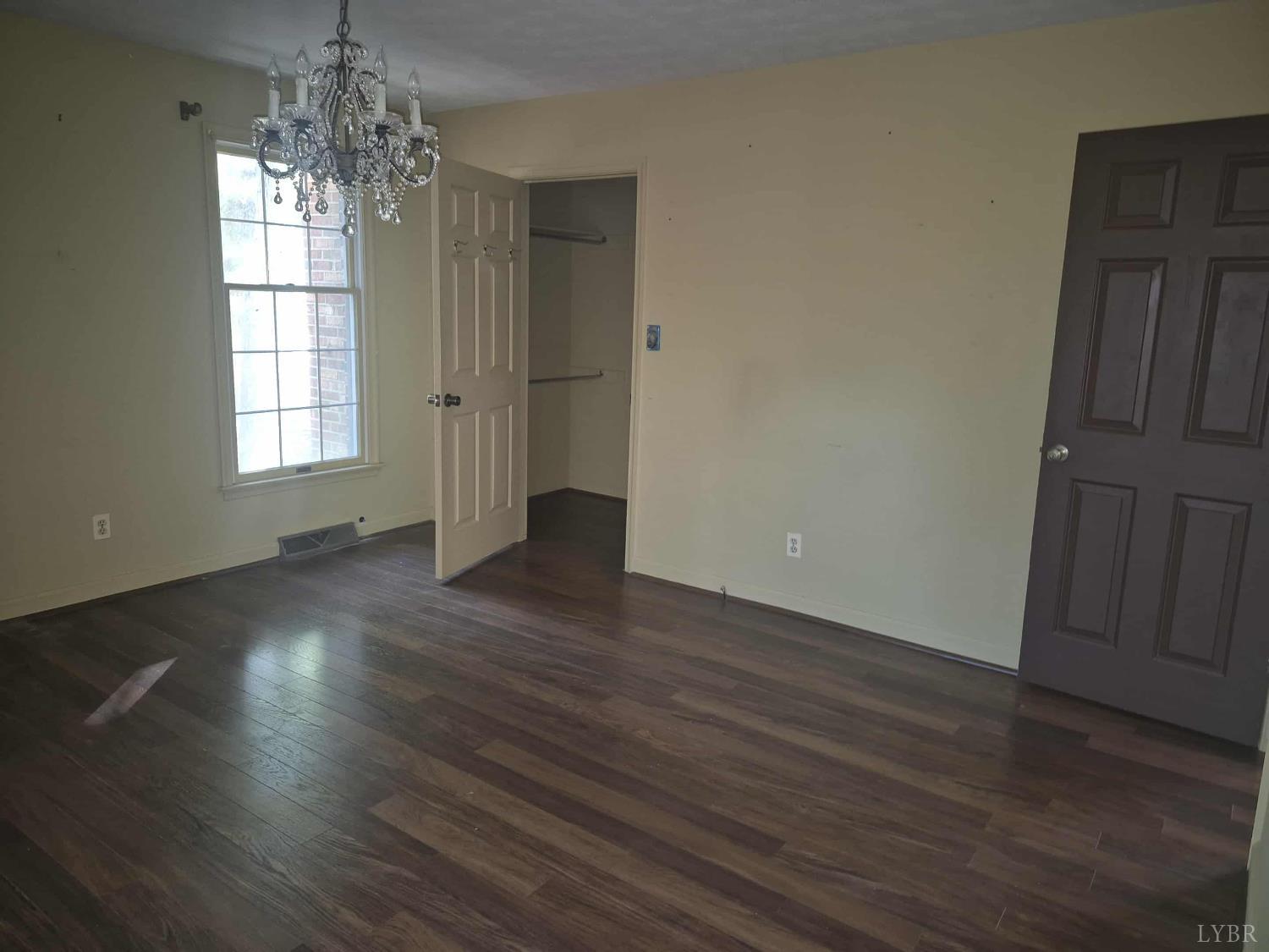 404 Darrell Lane Hurt, VA 24563 - Photo 14 of 31 an empty room with wooden floor and windows