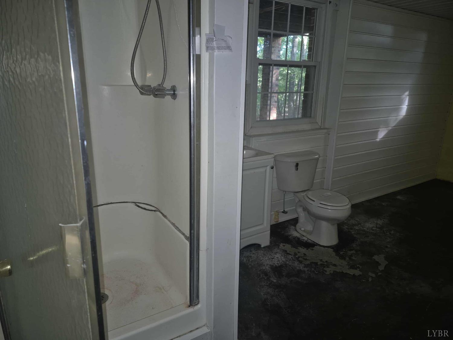 404 Darrell Lane Hurt, VA 24563 - Photo 18 of 31 a bathroom with a granite countertop toilet and a shower