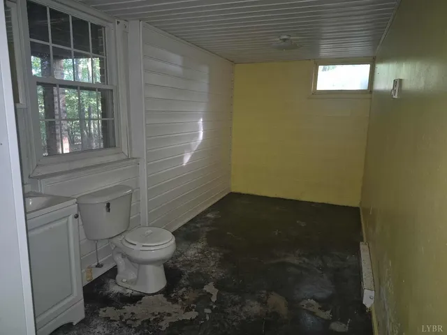 a bathroom with a granite countertop toilet and a shower