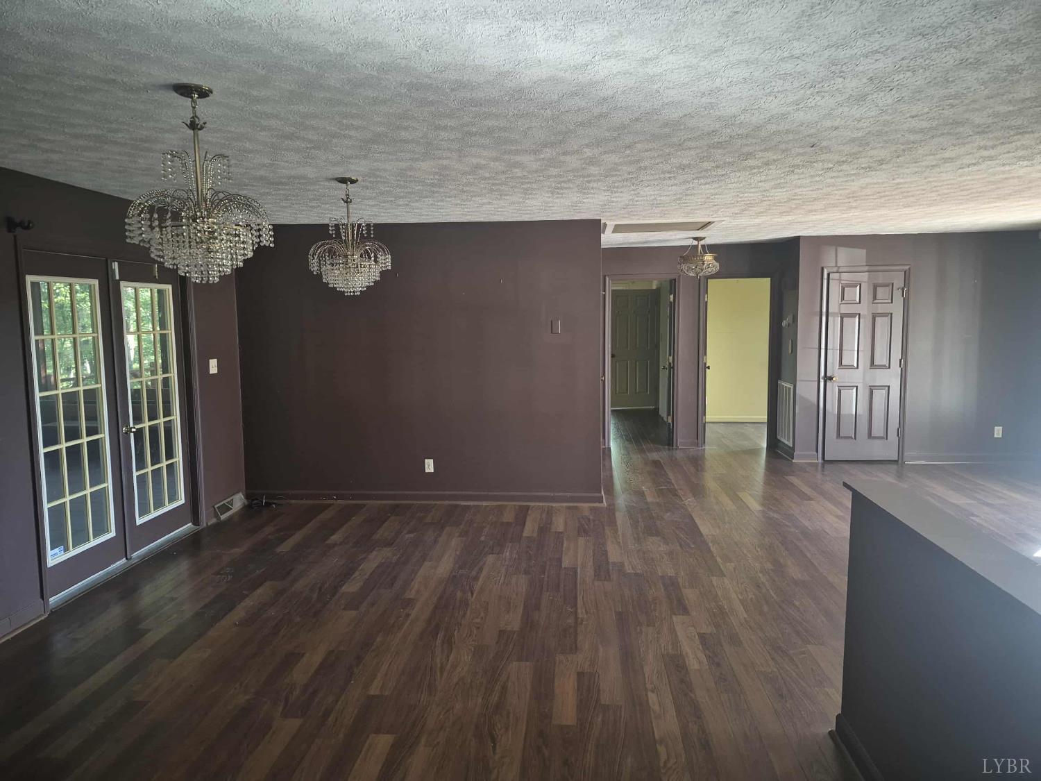 404 Darrell Lane Hurt, VA 24563 - Photo 28 of 31 an empty room with wooden floor and chandelier