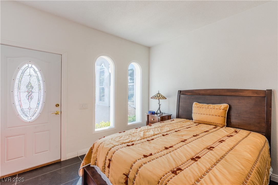 2339 Prometheus Court Henderson, NV 89074 - Photo 14 of 92 Bedroom featuring dark tile patterned floors and b