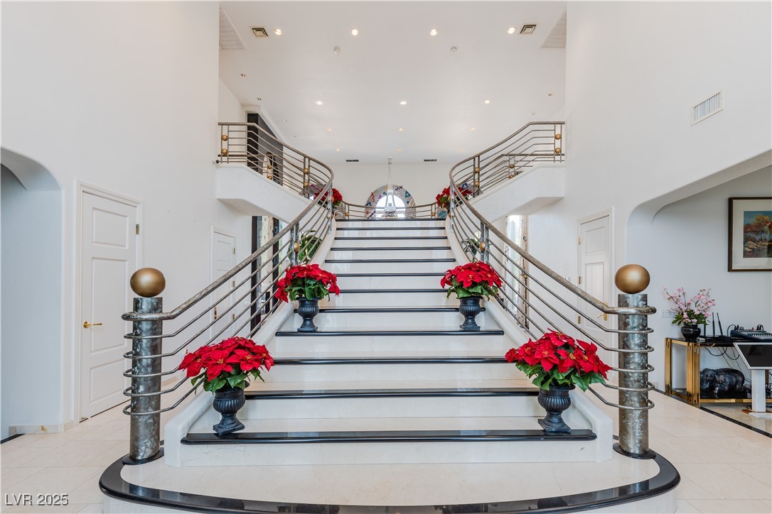 2339 Prometheus Court Henderson, NV 89074 - Photo 23 of 92 Stairway featuring arched walkways, a high ceiling