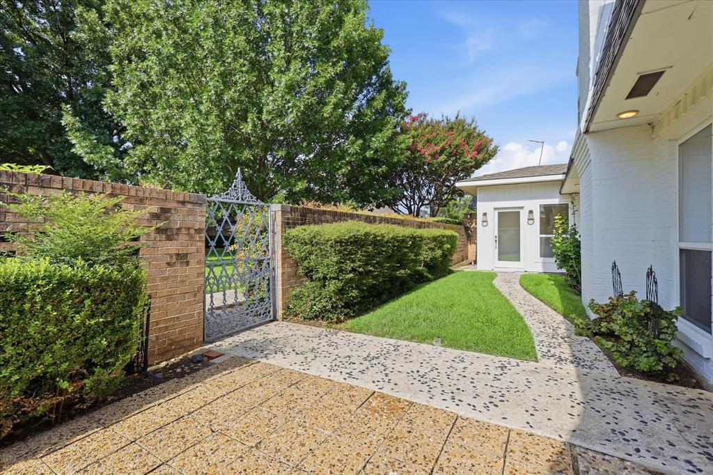 4310 Forest Bend Road Dallas, TX 75244 - Photo 33 of 40 White brick exterior with a pebble-dash pathway leading to the entry