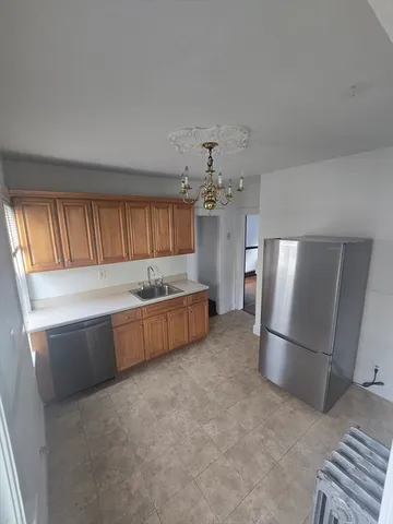 a large kitchen with a refrigerator and a sink
