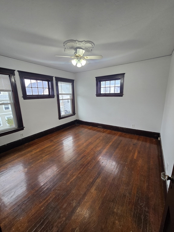 70 Montcalm Avenue, Unit 2 Boston, MA 02135 - Photo 5 of 8 a view of an empty room with wooden floor and a window