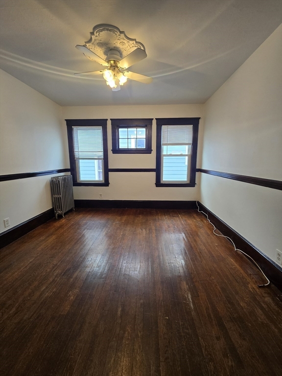 70 Montcalm Avenue, Unit 2 Boston, MA 02135 - Photo 6 of 8 a view of empty room with wooden floor and fan