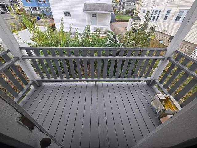 a balcony with wooden floor
