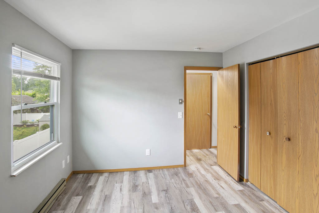 405 East Reed Street, Unit 13 Braidwood, IL 60408 - Photo 6 of 9 a view of hallway with window and wooden floor
