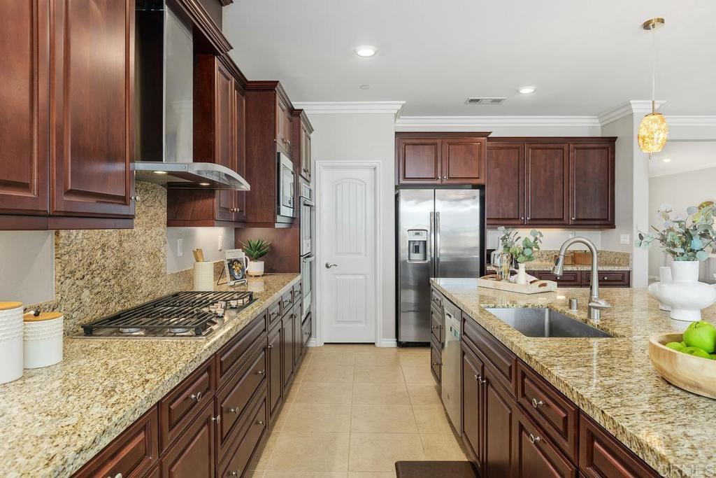 33802 Edge Lane Temecula, CA 92592 - Photo 12 of 31 a kitchen with stainless steel appliances granite countertop a sink stove and refrigerator