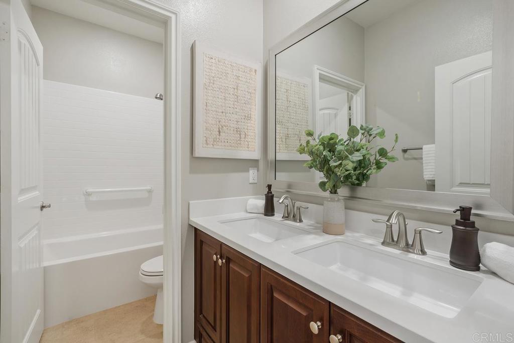 33802 Edge Lane Temecula, CA 92592 - Photo 21 of 31 a bathroom with a granite countertop sink and a mirror