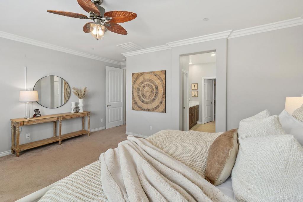 33802 Edge Lane Temecula, CA 92592 - Photo 23 of 31 a bedroom with a bed a chandelier and dresser
