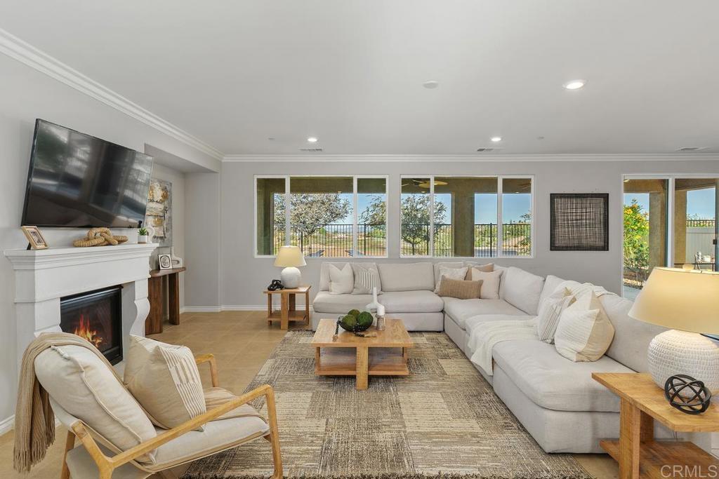 33802 Edge Lane Temecula, CA 92592 - Photo 6 of 31 a living room with furniture a flat screen tv and a fireplace