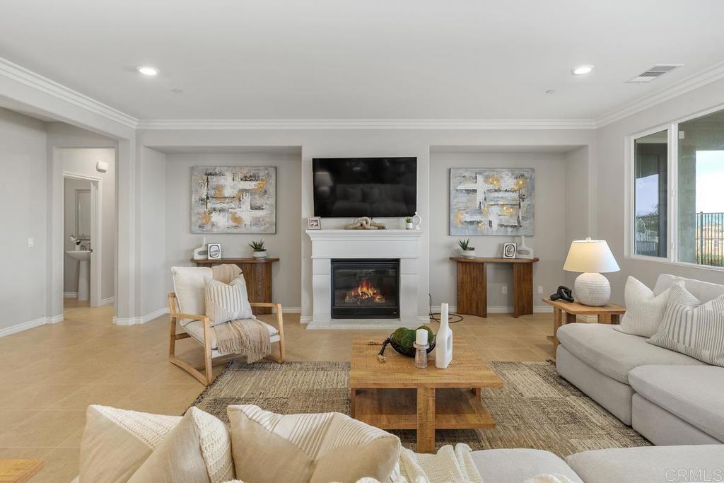 33802 Edge Lane Temecula, CA 92592 - Photo 7 of 31 a living room with furniture a flat screen tv and a fireplace