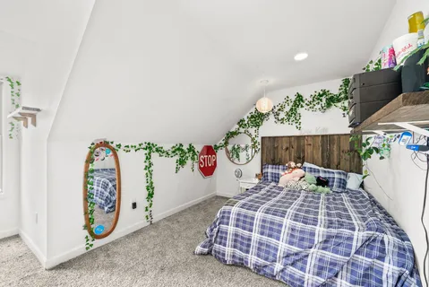 a view of a room that has a bed and a dresser in it