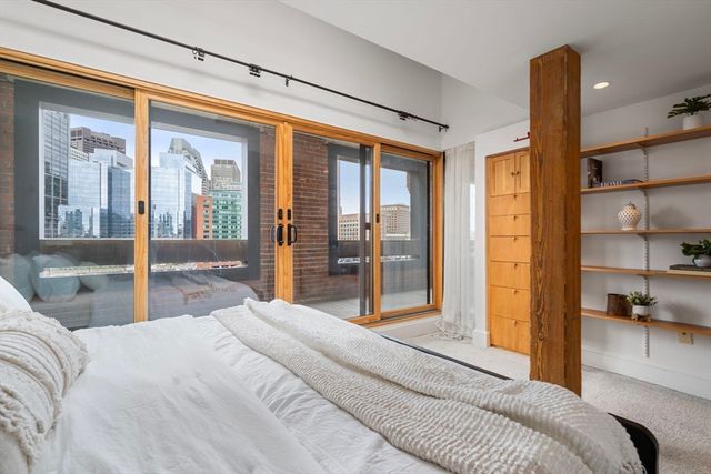 a bedroom with a large bed and a large window