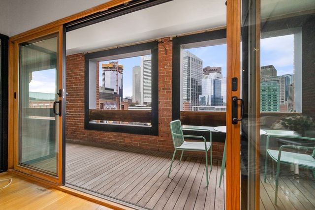 a view of a balcony with furniture and wooden floor