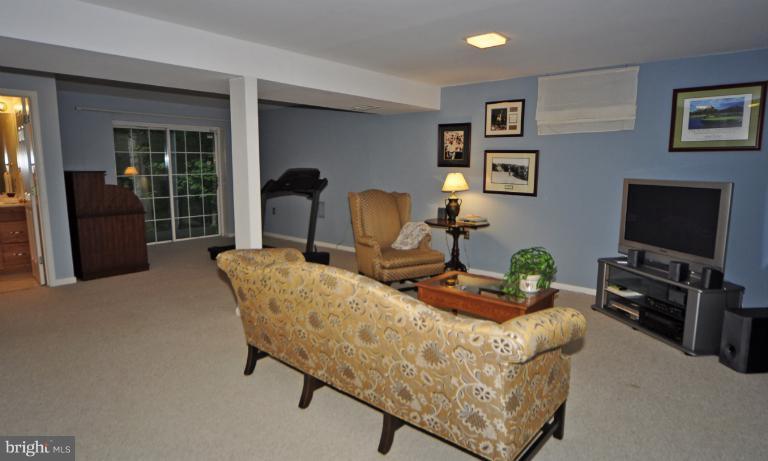 1943 Barton Hill Road Reston, VA 20191 - Photo 11 of 28 a living room with furniture and a flat screen tv