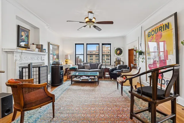 a living room with furniture a fireplace and a window